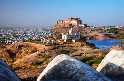 Mid distant view of mehrangarh fort and jaswant thada against clear sky