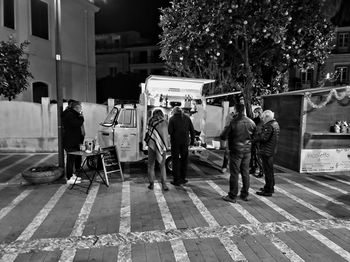 People walking on footpath in city