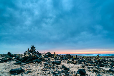 Rocks on beach against sky