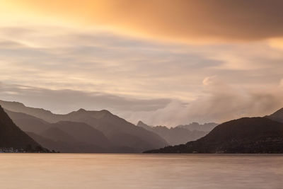 Scenic view of lake and mountains against sky