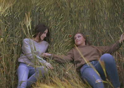 High angle view of two women sitting on grass