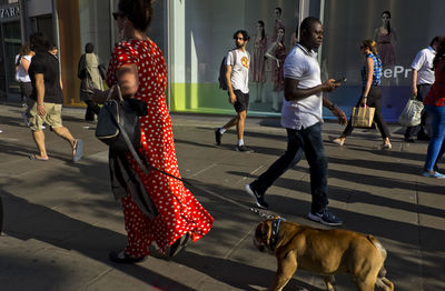 People with dog on street in city