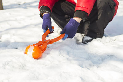 Low section of man skiing on snow