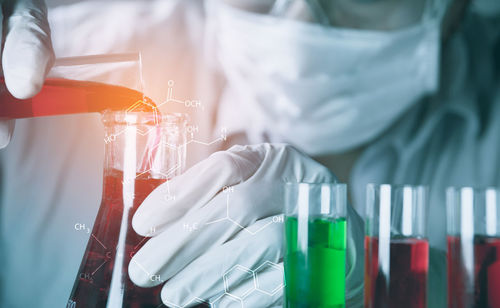 Digital composite image of man examining chemical in laboratory
