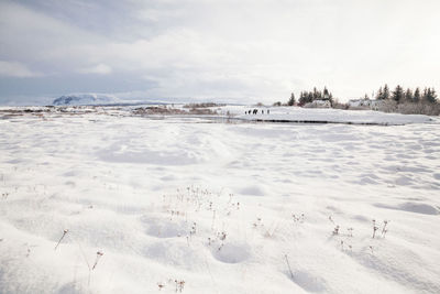 Scenic view of snow covered land against sky