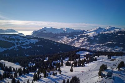 Scenic view of snowcapped mountains against blue sky