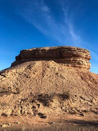 Low angle view of rock formation against blue sky