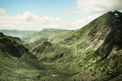 Scenic view of mountains against cloudy sky
