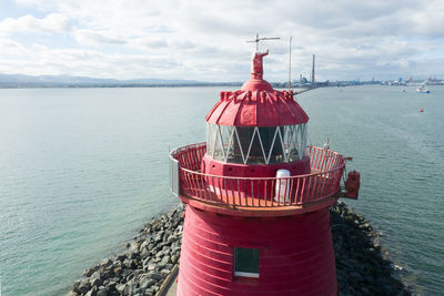 Close-up aerial view of poolberg lighthouse on coastline of dublin at sunny day