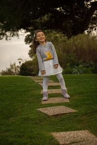 Portrait of smiling girl standing on field