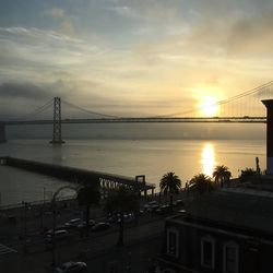 Bridge over river at sunset