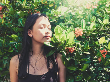 Close-up of young woman with flowers