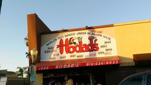 Low angle view of sign board against clear sky