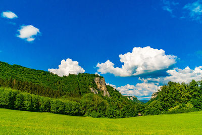 Panoramic view of landscape against blue sky