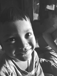 Close-up of cute smiling boy at home