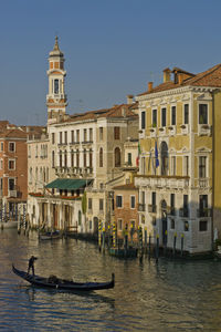 Buildings by grand canal in city