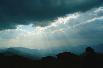Scenic view of mountains against cloudy sky