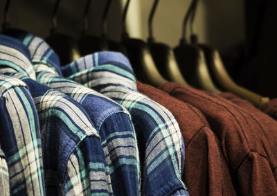 Close-up of shirts hanging on hangers at store