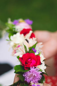 Close-up of hand holding rose bouquet