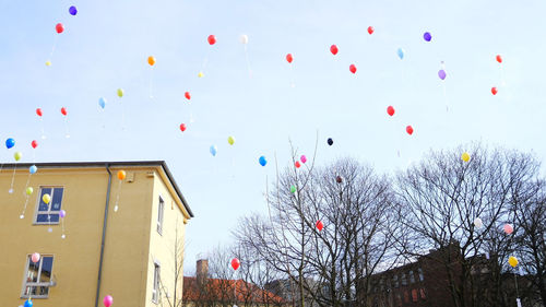 Low angle view of balloons against sky