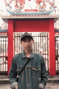 Portrait of a young man standing in front of a chinese temple