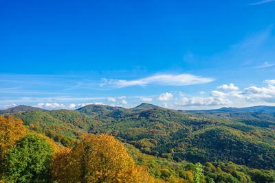 Scenic view of green mountains against sky