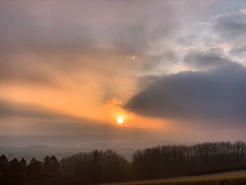 Scenic view of field against sky during sunset