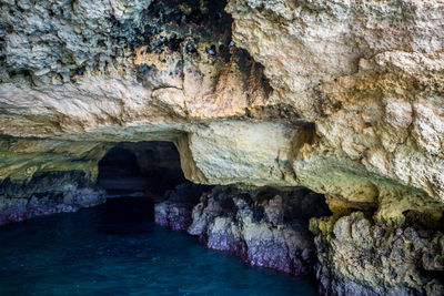 Scenic view of sea seen through cave