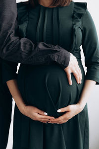 Midsection of woman holding hands