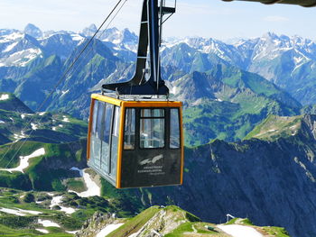 Overhead cable car over snowcapped mountains