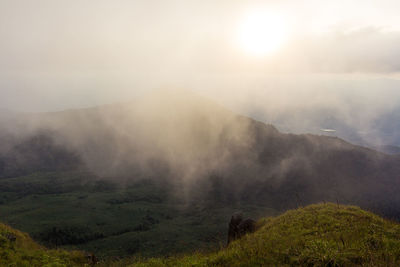 Scenic view of mountains against sky during foggy weather