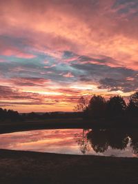 Scenic view of lake against orange sky