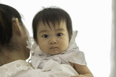 Portrait of cute baby girl with mother