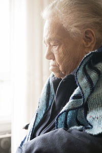 Side view of woman looking at home