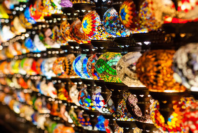 Colorful lamps on shelves for sale at store