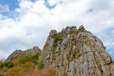 Low angle view of rocks on mountain against sky