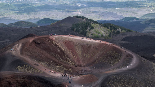 High angle view of tourists on volcanic crater