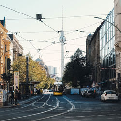 Vehicles on road against buildings in city