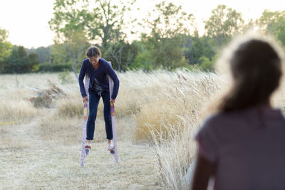 Woman walking on stilts