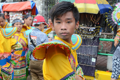 Portrait of young man standing against multi colored