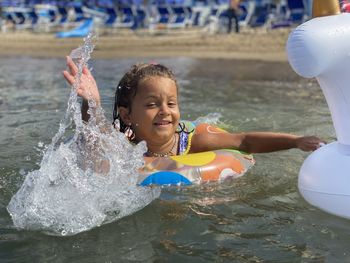 Portrait of happy girl in swimming pool