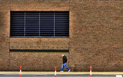 Rear view of man and woman on wall