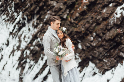 Young couple standing on rock