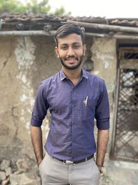 Portrait of young man standing outdoors