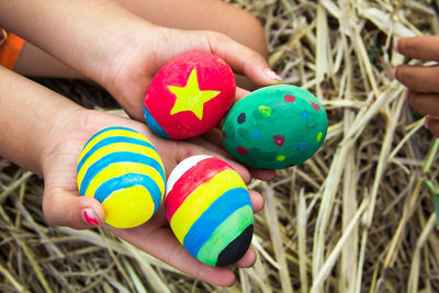 Midsection of person holding multi colored candies