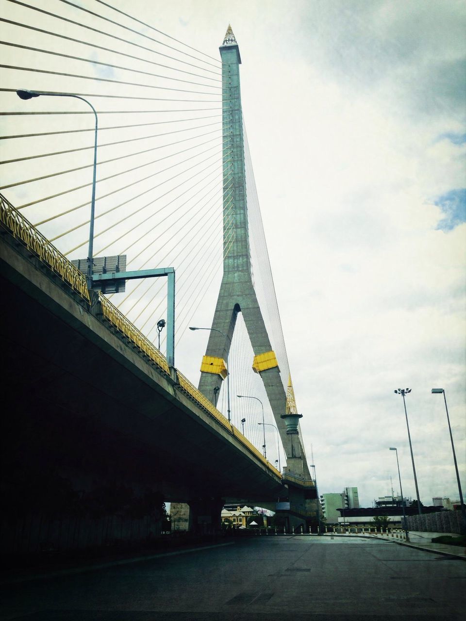 architecture, built structure, transportation, connection, bridge - man made structure, sky, engineering, the way forward, road, cloud - sky, city, building exterior, bridge, suspension bridge, low angle view, cable-stayed bridge, diminishing perspective, long, cloud, outdoors