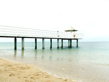 Pier over sea against clear sky