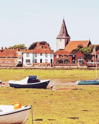 Boats moored in water against clear sky