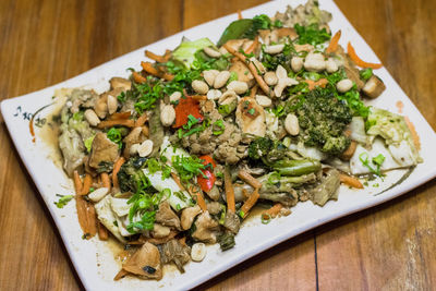 High angle view of chopped vegetables in plate on table