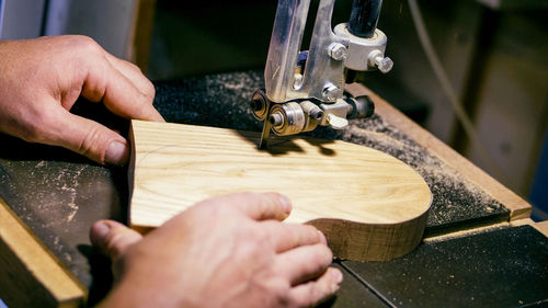 Close-up of person hand by machinery